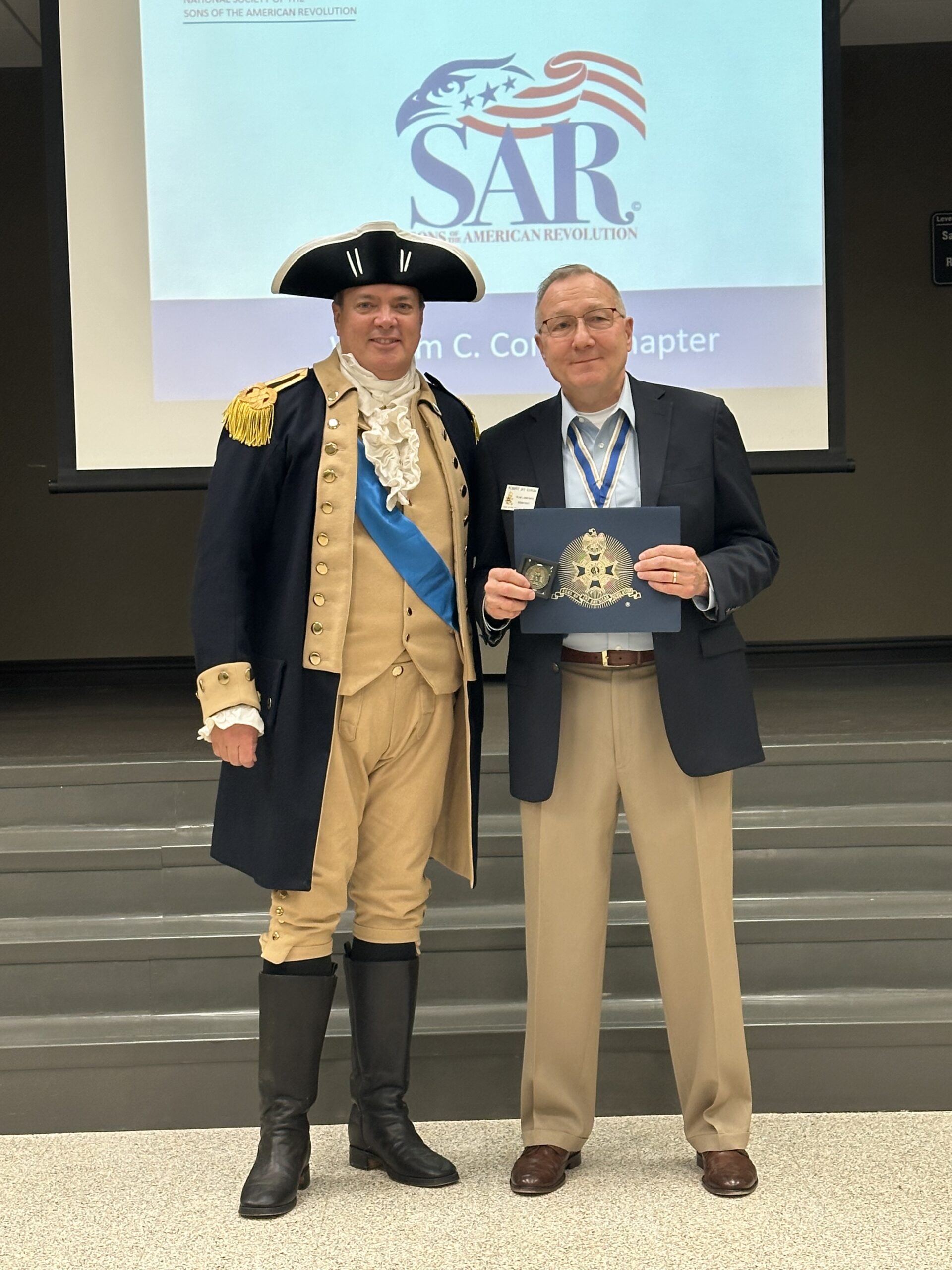 Speaker Robert Corum receives certificate of application from Chapter President, Darrell Jones.